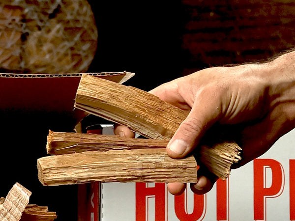 Hand holding a six-inch mini split for portable wood-fired ovens