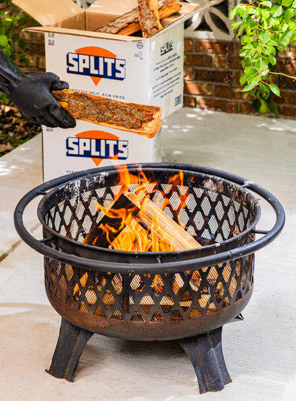 Adding SPLITS kiln-dried firewood to a backyard fire pit