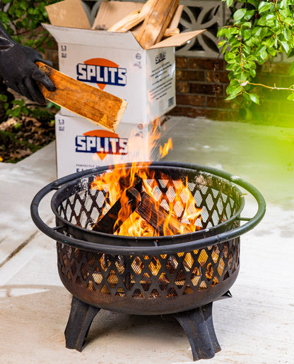 Adding SPLITS kiln-dried firewood to a backyard fire pit